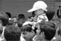 Kid finds it cozy on dad's shoulder.