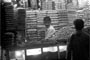 Snack shop attendant busy with the customer sale.