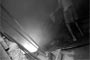 A factory worker melts waste metal scrap in extreme heat.